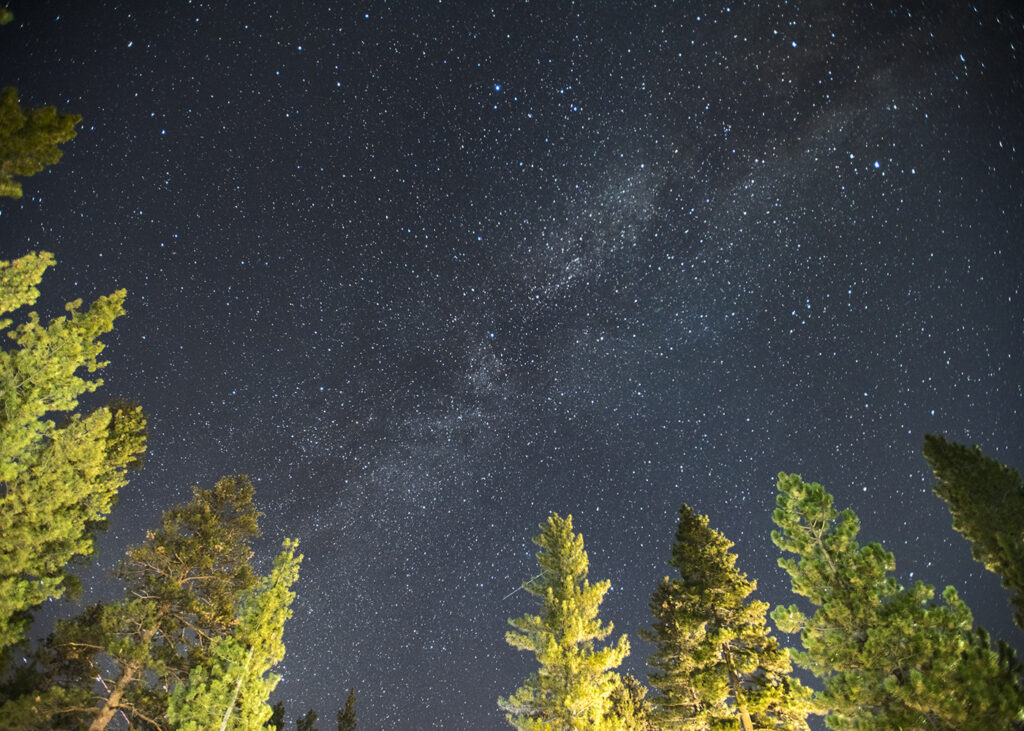 Eating camp cooking out under a stary sky