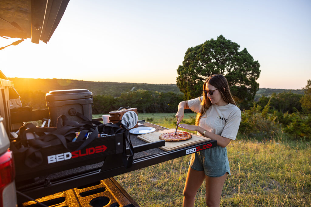 Eating pizza on a tailgate pickup truck BEDSLIDE